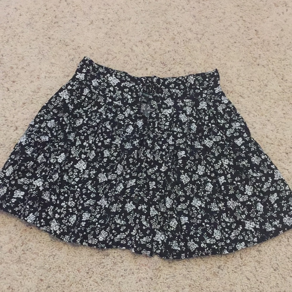 Black skirt with white flower pattern and buttons